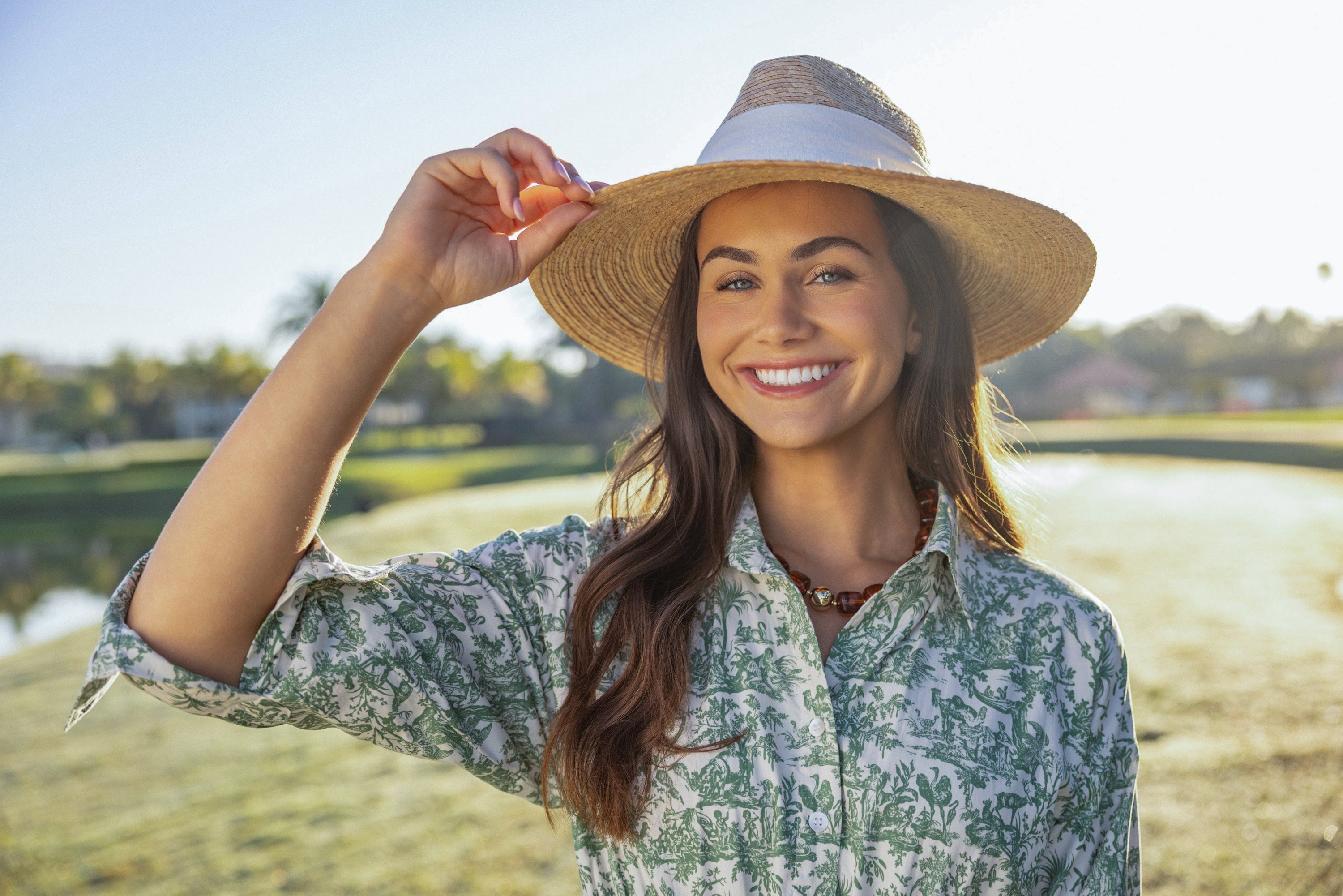 Woman wearing a lightweight UPF 50+ dress outdoors in the sun, styled for everyday wear and sun protection