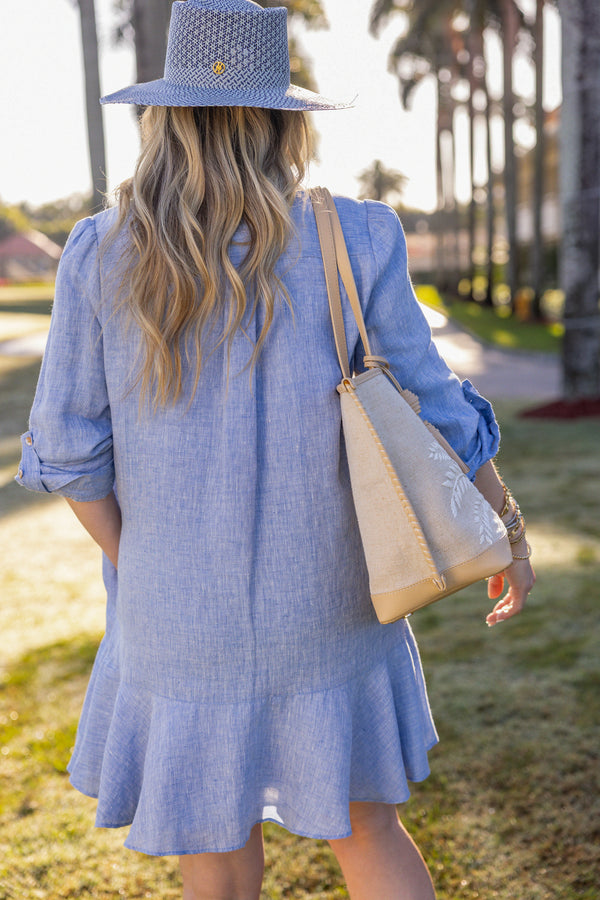 Woman wearing UPF 50+ blue button down mini dress with sun protection at the country club