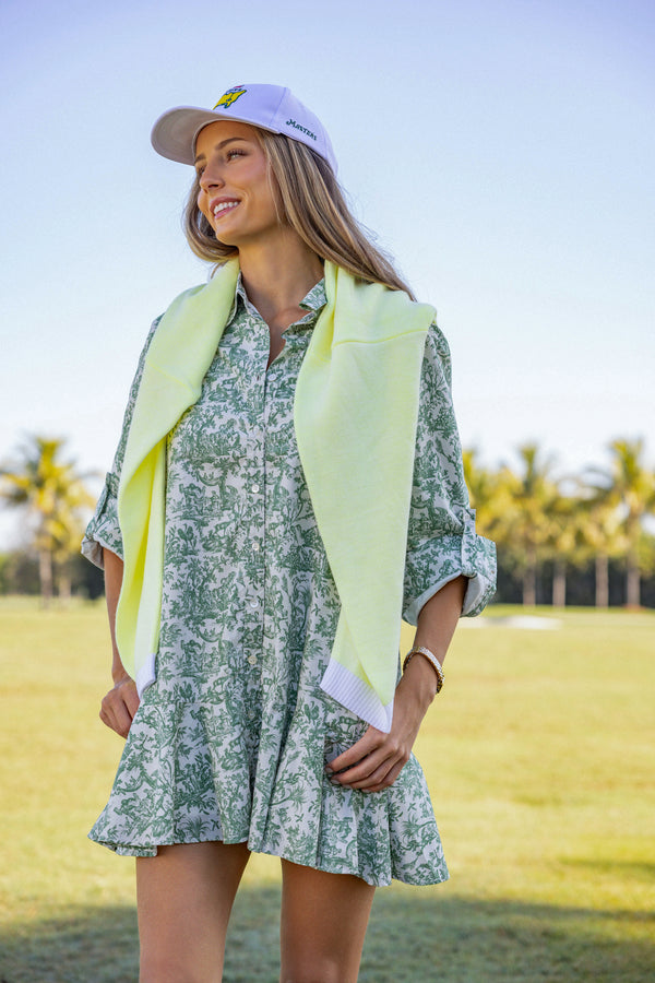 Woman wearing UPF 50+ floral green button down mini dress with sun protection at the country club
