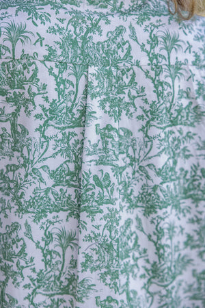 Close-up of green floral patterned fabric on a white background