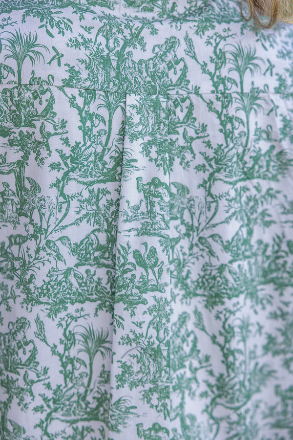 Close-up of green floral patterned fabric on a white background