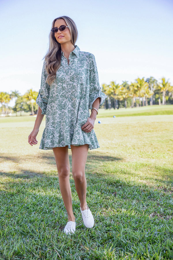 Woman wearing UPF 50+ floral green button down mini dress with sun protection at the country club
